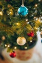 A small Christmas tree in a pot, decorated with balls, garlands Royalty Free Stock Photo