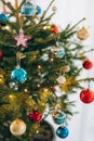 A small Christmas tree in a pot, decorated with balls, garlands Royalty Free Stock Photo