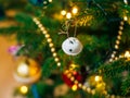 A small Christmas tree in a pot, decorated with balls, garlands Royalty Free Stock Photo