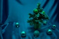 A small Christmas tree in a pot, decorated with balls, garlands and lights. Royalty Free Stock Photo