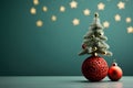 Small Christmas tree and red baubles and gold stars on the right. Green background. Side view.Christmas banner with space for your Royalty Free Stock Photo