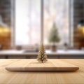 Small Christmas tree on top of cutting board. The tree sits in front of window with view of outside world through it Royalty Free Stock Photo