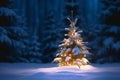 Small Christmas tree in a winter forest in snow decorated with sparkling colorful lit garland. Golden light glow. Holiday card