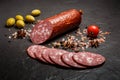 small chunk of dry smoked salami sausage with olives and tomato Royalty Free Stock Photo