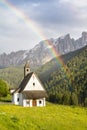 Small church in Alps under the rainbow Royalty Free Stock Photo