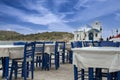 Small church and an empty tavern by seaside .Greece . Royalty Free Stock Photo