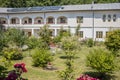 Small church, pleasant countryside view against blue sky. Country road and idyllic pastoral village landscape near Valcea county Royalty Free Stock Photo