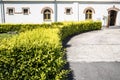 Small church, pleasant countryside view against blue sky. Country road and idyllic pastoral village landscape near Valcea county Royalty Free Stock Photo