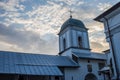 Small church, pleasant countryside view against blue sky. Country road and idyllic pastoral village landscape near Valcea county Royalty Free Stock Photo