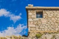 Small church on rock stone wall background texture pilgrim way place blue sky