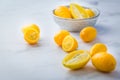 Small citrus fruits limequat with bowl on table