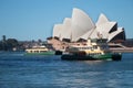 Small city ferry in front of the Sydney Opera House, waterfront and blue sky, Sydney Royalty Free Stock Photo