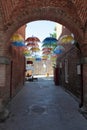 Small city street of bricks with umbrellas