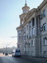 Small city street with a very beautiful white old building with columns and a tower in Sevastopol, in Crimea Royalty Free Stock Photo