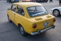 Small classic Spanish economy car, the Seat 850 in yellow color Royalty Free Stock Photo