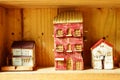Small clay house model in woodshelf interior decorate Royalty Free Stock Photo