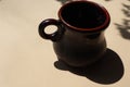 A small clay mug for dark coffee Royalty Free Stock Photo