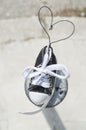 Small clean torn sneaker toy with heart shaped rope