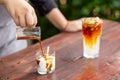 A small clear glass filled with white coconut ice cream and poured coffee. There is coconut water mixed with coconut meat in a Royalty Free Stock Photo