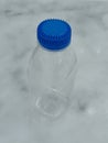 Small clear plastic bottle with a blue cap Royalty Free Stock Photo