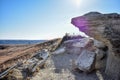 A small cliff edge hovers over a nature path.