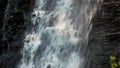 Small cliffy mountain waterfall on a sunny day.