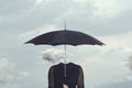 Small cloud that repairs from the rain under the umbrella of a headless woman Royalty Free Stock Photo