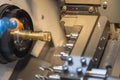 The small CNC lathe cutting the brass shaft