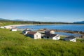 Small coastal houses with grass and water