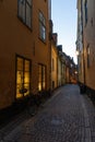 Small cobbled street in the old town of Stockholm, Sweden in the evening with bike leaning towards the wall Royalty Free Stock Photo