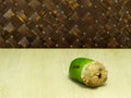 Small coconut isolated on table in weave background