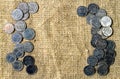 Small coins on the background of burlap.