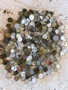 Small coins of different denominations lie on a stone