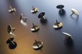 A Small Collection Of Thumbtacks With Reflecting Colors On Dark Ground