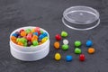 Small colored candies in the plastic container Royalty Free Stock Photo