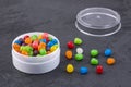 Small colored candies in the plastic container