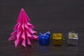 Small colored gifts on the table.pink spruce paper