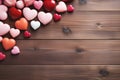 Small colored hearts on wooden plank background. Mockup for wallpapers, backgrounds, postcards on Valentine's day