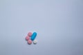 Small colored pills on a neutral background. Free space to write