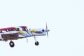 Small, colorful airplane ascending with parachuters on board. Royalty Free Stock Photo