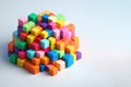 Small, colorful cubes lying in a pile on a light background. Space for text. Royalty Free Stock Photo