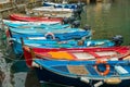 Small colorful fisherman boats park at the pier in Manarola town, Cinque Terre, Italy