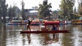 Small, colorful food boat being poled at Xochimilco