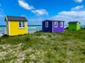 Small colorful houses under the sun at the beach on the island of Aero in Denmark