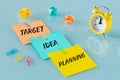 notes with slogans; Goal, Idea, Planning. Concept, yellow alarm clock, washed away paper balls, colorful office staples Royalty Free Stock Photo