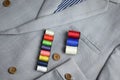 Small colorful thread coil on grey suit Royalty Free Stock Photo
