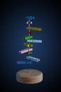 Small colorful wooden pegs on a pole on dark background. Royalty Free Stock Photo