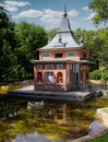 Small coloured building in an urban lake