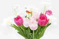 A small colourful bouquet of tulips in white porcelain vase