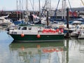 Small commercial fishing boat in scarborough harbour surrounded by yachts and trawlers Royalty Free Stock Photo